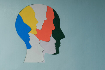 Wall Mural - paper cut style Colored silhouette faces in head. Metaphor bipolar disorder,  Parkinson, Double face, Split personality, Psychology, Dual personality Mental health concept. Copy space.