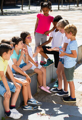 Wall Mural - Company of children are communicating on walk in the city