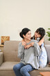 © bongkarn - Lovely Asian mom and daughter playing and spending time together in their living room.