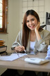 © bongkarn - Portrait, Beautiful Asian businesswoman or female boss in casual suit sits at her office desk