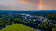An Aerial Shot Of The Vast Miles Of Lush Green Trees And Grass With Buildings Nestled Among The Trees And Powerful Clouds And A Rainbow At Etowah River Park In Canton Georgia USA