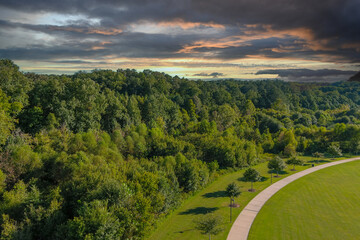 an aerial shot of a gorgeous autumn landscape at etowah river park with lush green trees, grass and 