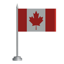 Flag Of Canada On A Flagpole Stands On The Table