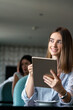 © NDABCREATIVITY - Young professional businesswoman sitting at table at cafe