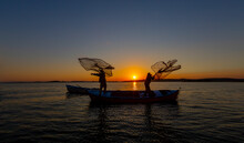 Fishermen Casting Nets In The Lake