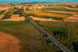 Aerial shot of straight highway through cultivated agricultural fields in Vojvodina, Serbia