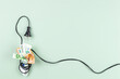© vejaa - Euro banknotes are tightly wrapped with electric power cable cord. Energy efficiency, power consumption, rising electricity price and expensive energy concept