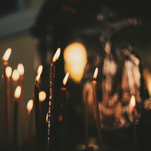 Church Candles Close-up, Against The Background Of A Specially Blurred Religious Cross