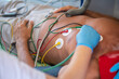 © zinkevych - Experienced paramedic listening to the adult man heartbeat with the stethoscope