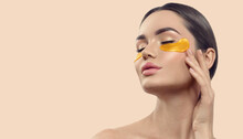 Woman With Under Eye Collagen Gold Pads, Patches, Beauty Model Girl Face With Healthy Skin. Skin Care Concept, Anti-aging Moisturizing Eye Mask, Golden Hydrogel, Eye Skin Treatment, Cosmetology.