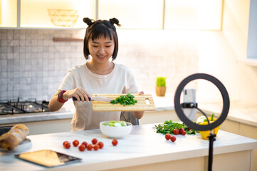 Female cook preparing a vegan dish in her cookery vlog