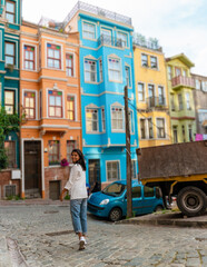 Sticker - Asian women on city trip Balat district Istanbul Turkey, colorful homes and houses in the town of Balat with tourists enjoying a beautiful summer day. 