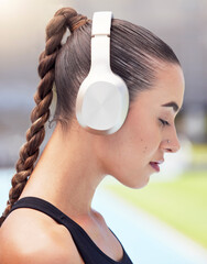 Sticker - Woman runner listening to music on headphones training for fitness marathon or triathlon streaming radio audio. Girl sports athlete workout, running and mp3 song exercise for cardio at track stadium