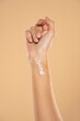 © vladimirfloyd - Close up cropped woman hand perfect skin hand cream isolated on beige studio  background. Skin care healthcare procedures concept.
