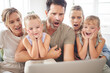 © David L/peopleimages.com - Family wow, streaming movie and kids with surprise at online email, shock at horror film on subscription service and notification on web on laptop. Parents and grandmother scared of news on tech