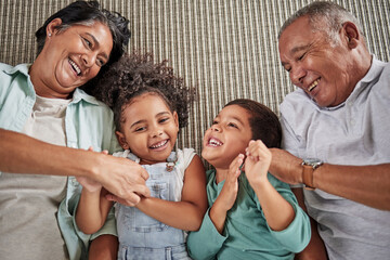 Canvas Print - Happy family, grandparents and children on a sofa, relax and laughing while bonding in e living room together. Love, laugh and happy kids playing, enjoy time and fun game with elderly man and woman