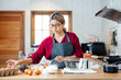 © vacancylizm - Beautiful young woman  is mixing batter, looking at camera and smiling while baking in kitchen at home ,decorating a cake of chocolate cake,cooking class, culinary, bakery, food and people concept