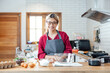 © vacancylizm - Beautiful young woman  is mixing batter, looking at camera and smiling while baking in kitchen at home ,decorating a cake of chocolate cake,cooking class, culinary, bakery, food and people concept