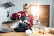 © vacancylizm - Beautiful young woman  is mixing batter, looking at camera and smiling while baking in kitchen at home ,decorating a cake of chocolate cake,cooking class, culinary, bakery, food and people concept