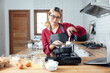 © vacancylizm - Beautiful young woman  is mixing batter, looking at camera and smiling while baking in kitchen at home ,decorating a cake of chocolate cake,cooking class, culinary, bakery, food and people concept
