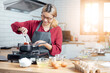 © vacancylizm - Beautiful young woman  is mixing batter, looking at camera and smiling while baking in kitchen at home ,decorating a cake of chocolate cake,cooking class, culinary, bakery, food and people concept