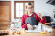 © vacancylizm - Beautiful young woman  is mixing batter, looking at camera and smiling while baking in kitchen at home ,decorating a cake of chocolate cake,cooking class, culinary, bakery, food and people concept