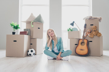 Sticker - Photo of charming shiny young lady dressed denim shirt legs crossed thinking about new home indoors apartment