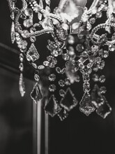 Vertical Greyscale Shot Of The Details Of A Gorgeous Chandelier