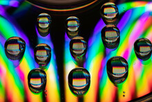 Drops Of Water On A CD Create An Explosion Of Color