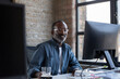 © ReeldealHD images - Portrait of African American businessman sitting at desk in an office