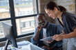 © ReeldealHD images - African American businessman smiling a presentation on digital tablet
