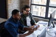 © ReeldealHD images - Coworkers using a digital tablet for a video call in the office