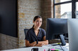 © ReeldealHD images - Portrait of young businesswoman working at a desktop computer in an office