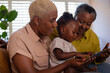 © ReeldealHD images - African American grandchild learning to use a digital tablet