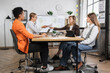 © sofiko14 - Focused business women in formal wear spending work time at office for monitoring financial market situation. Qualified females economists sitting at desk with modern laptop, tablet and huge display.