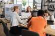 © sofiko14 - Four multi ethnic female economists sitting at office with various gadgets and analysing financial growth in worldwide economy. Female partners having business meeting.