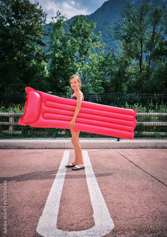 Woman In Inflatable Raft Girl holding inflatable pool raft in parking lot Stock Photo | Adobe Stock