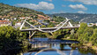 Panoramic view of landmark Millennium bridge over river Miño in the city of Ourense, Galicia, Spain.