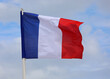 Big French Flag wavings on the blue sky without people