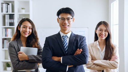 Portrait of smiling group Asian professional confident business people team standing and looking at camera