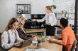 © sofiko14 - Multiracial female business people having briefing about financial situation at company. Cheerful blond woman pointing on monitor with various graphs and charts. Cooperation and brainstorming concept.