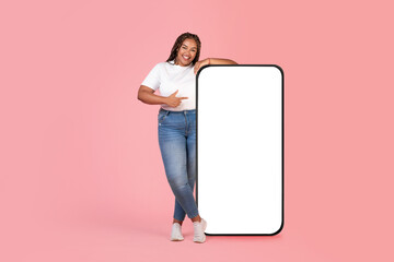 Wall Mural - African American Female Pointing At Large Smartphone Screen In Studio