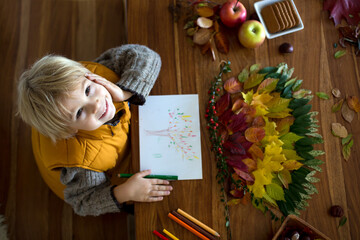 Wall Mural - Sweet child, boy, applying leaves using glue while doing arts and chraft with leaves