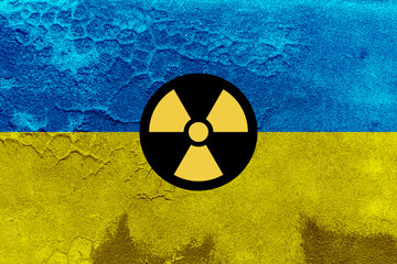 Flag of Ukraine and nuclear bombs concept. Ukrainian flag with chemical weapons symbol on grungy wall background.