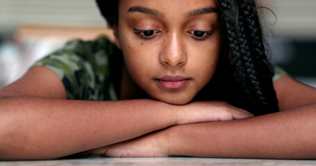 Wall Mural - Thoughtful pensive preteen adolescent girl looking down in contemplation