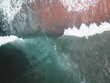 Aerial view of a surfer in the middle of a stormy ocean