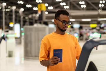 Wall Mural - Young black man ready to travel at airport terminal waiting for flight