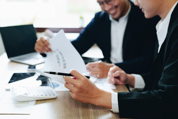 Teamwork concept, consultation, male economist using documents budget, finance and investment documents, discussing and planning finances with female advisors in conference room