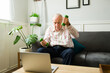 © AntonioDiaz - Healthy old man working out and watching exercise videos