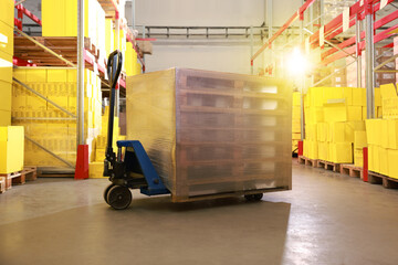 Poster - Modern manual forklift with wrapped wooden pallets in warehouse